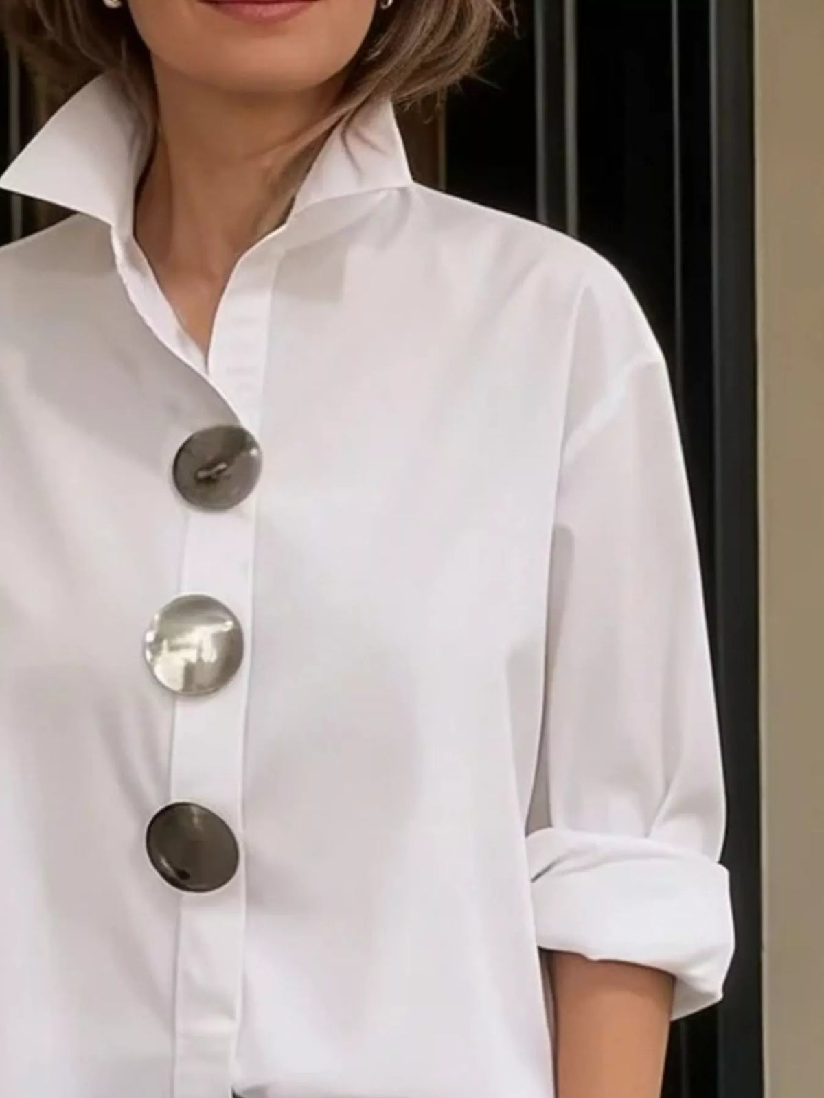 White long-sleeve button shirt with metallic round buttons and point collar, close view
