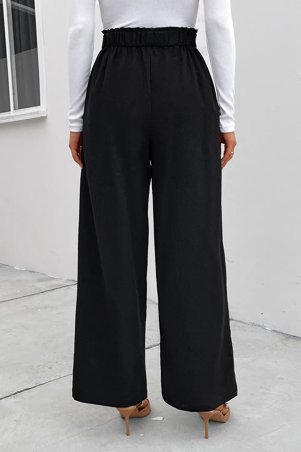 Black wide-leg pants with elastic waist and full-length drape