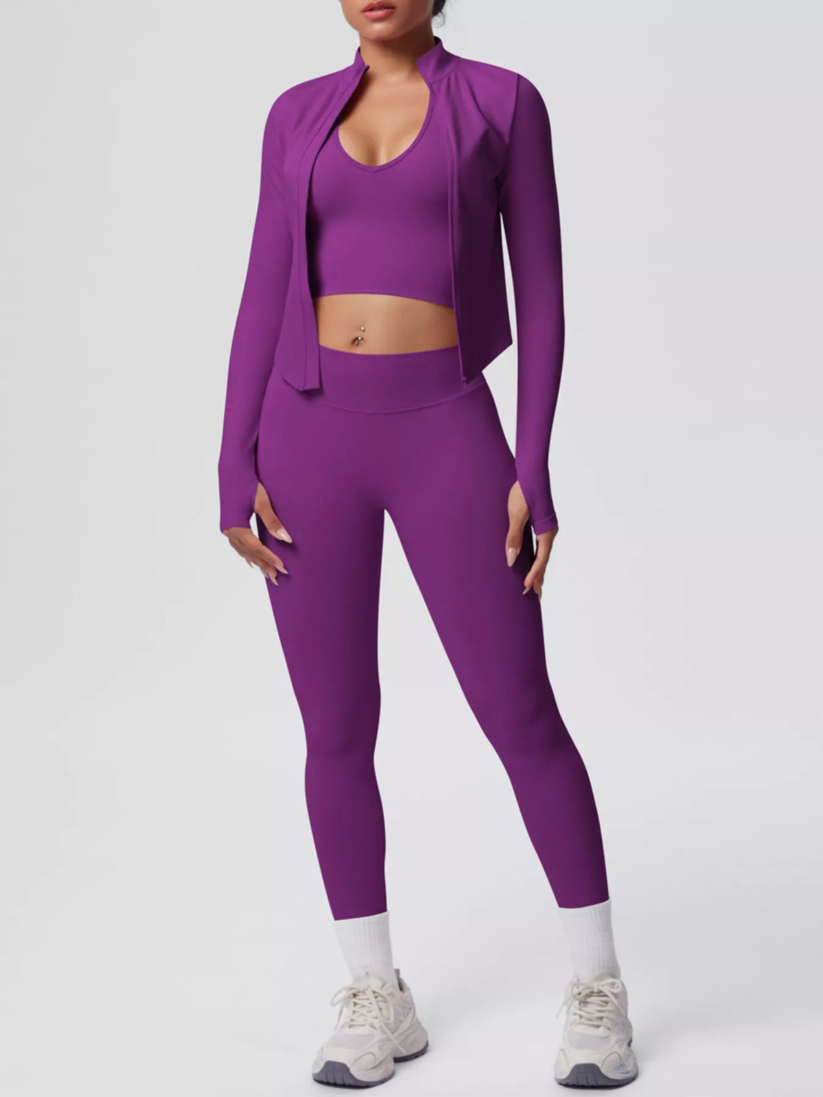 Purple three-piece workout set with long-sleeve open jacket, sports bra and leggings
