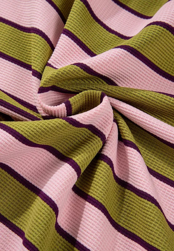 Striped knit fabric swatch, pink base with olive-green and purple horizontal stripes