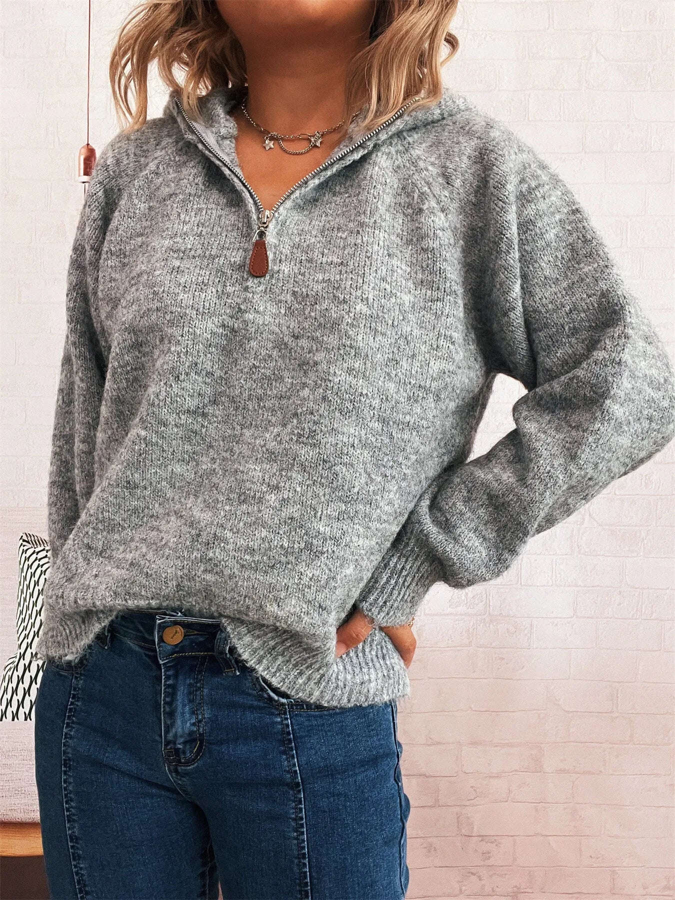 Dark gray quarter-zip knit sweater with ribbed hem and zipper pull