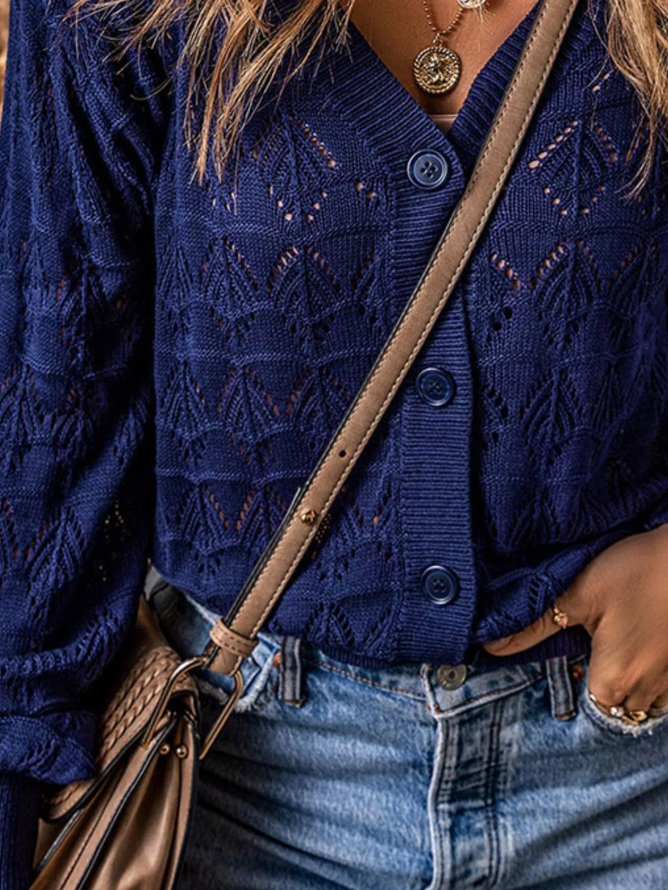 Blue openwork button-up cardigan front with V-neck, buttons, and textured knit pattern
