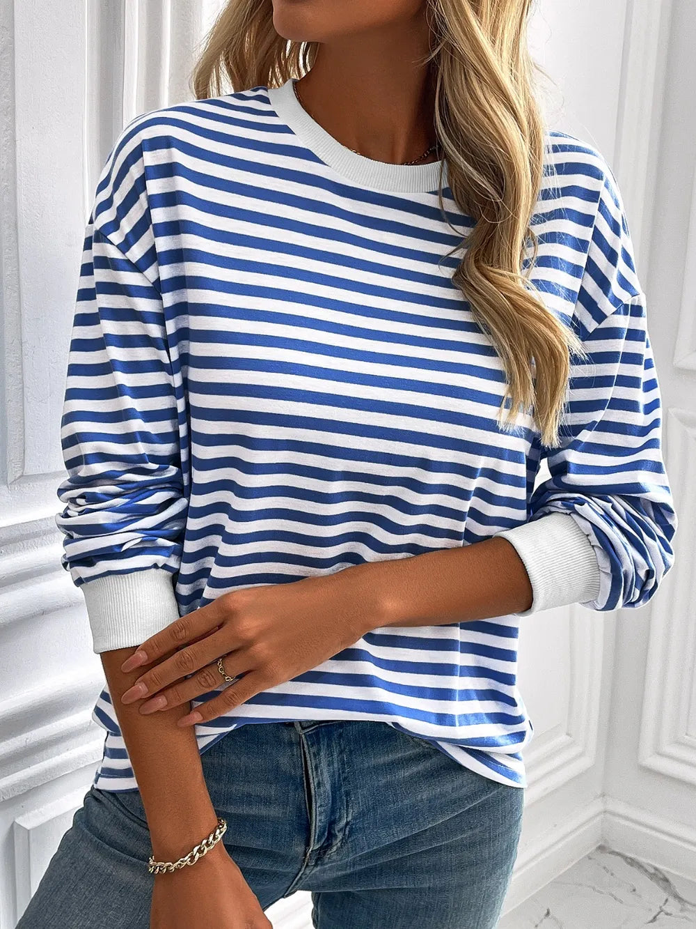 Striped crewneck long-sleeve sweatshirt in blue and white, sleeve detail view