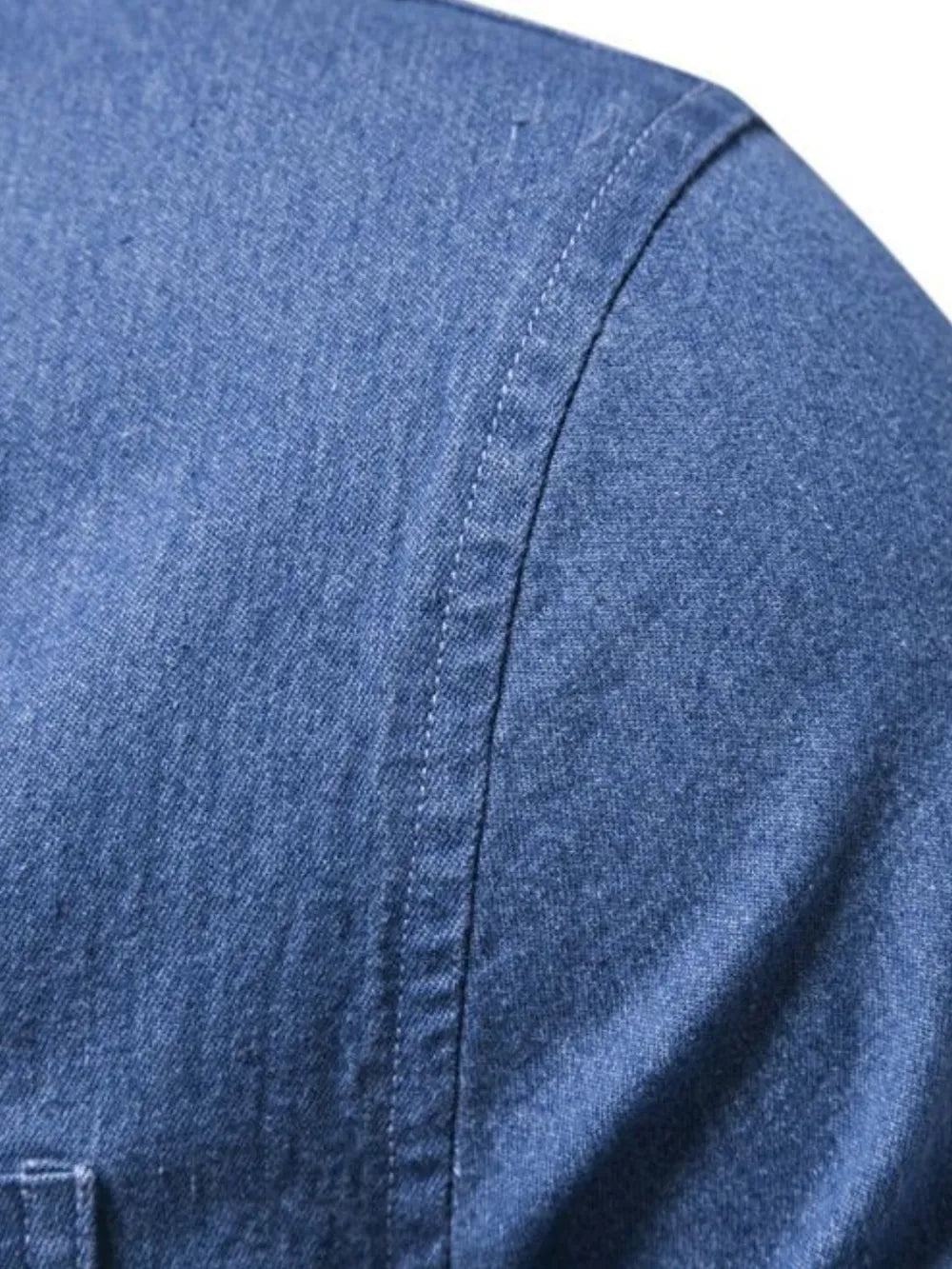 Denim button-up shirt closeup of side seam and curved yoke