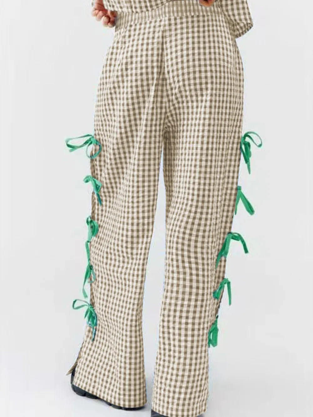Tan plaid wide-leg pants with green side ties on the legs