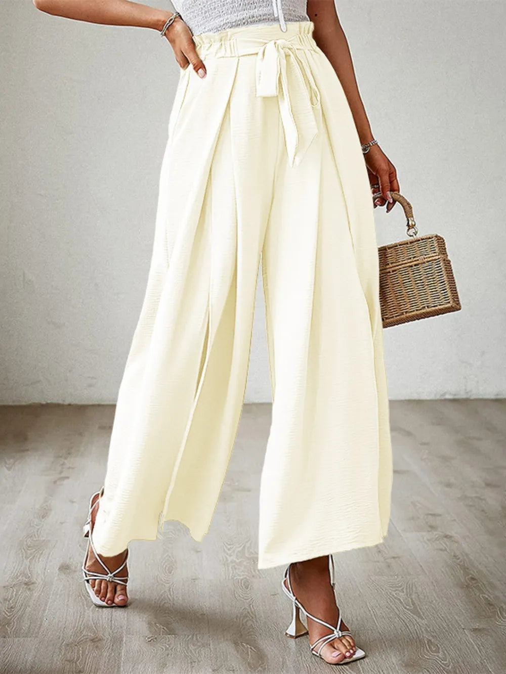 Pastel yellow tied-waist wide-leg pants with front ribbon tie and loose drape