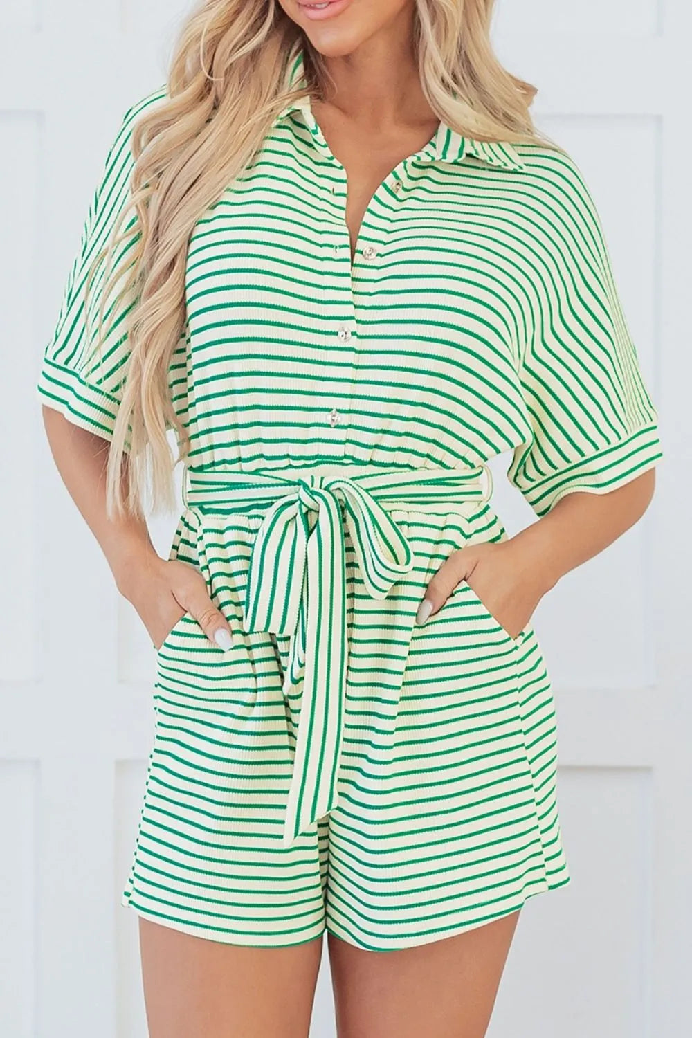 Green and white striped romper with half sleeves, button front, and tied waist