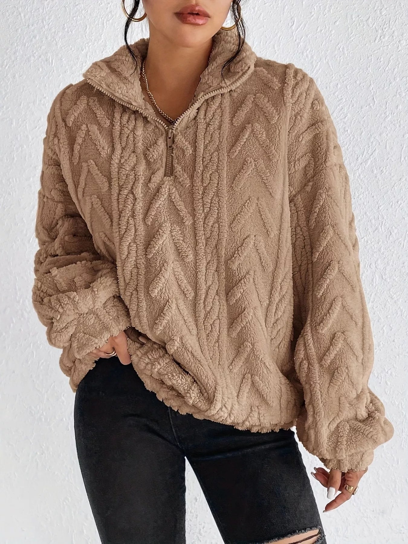 Beige sherpa quarter-zip sweatshirt with cable-knit texture and dropped shoulders