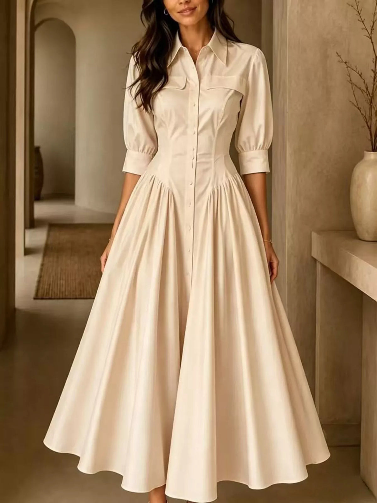 Beige button-down shirt dress with cinched waist and flared, pleated skirt