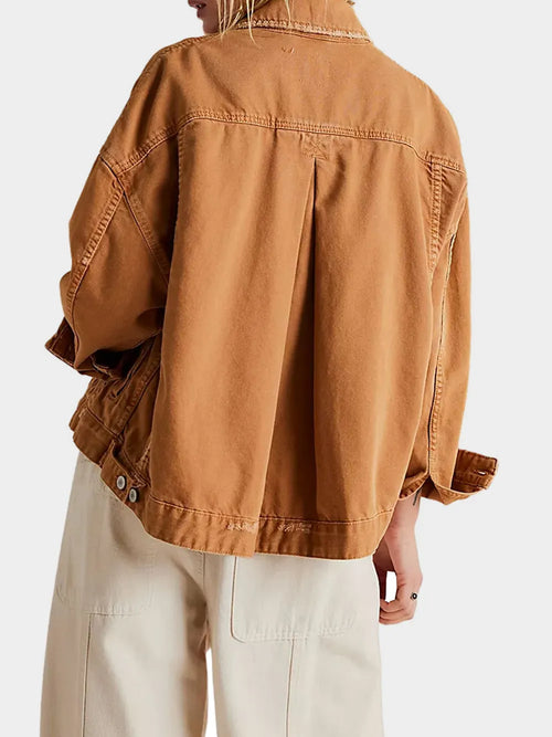 Caramel denim jacket back with yoke seams and buttoned chest pockets