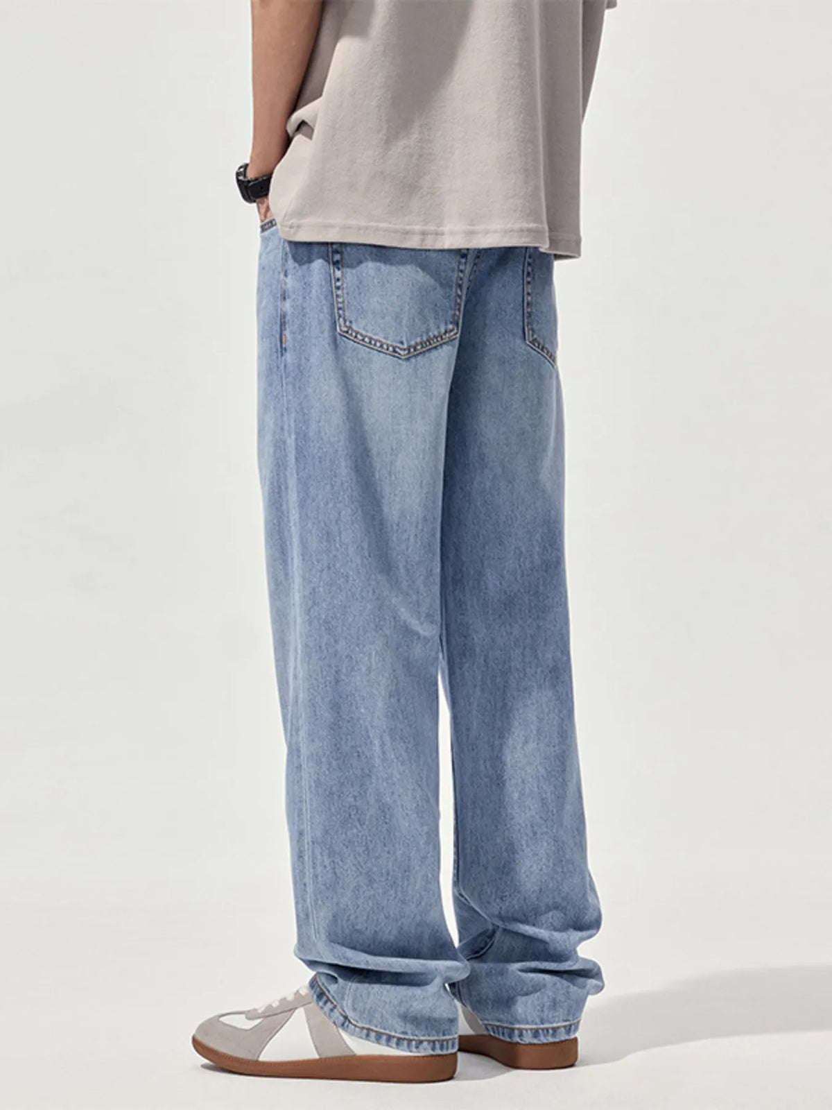 Light blue washed straight jeans with relaxed fit, visible front pocket and belt loops