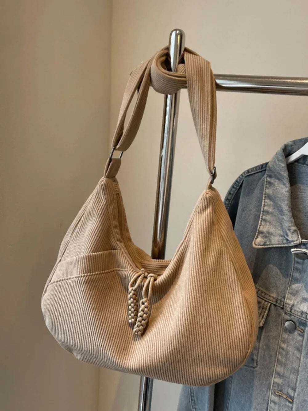 Beige ribbed shoulder bag with adjustable strap and drawstring top