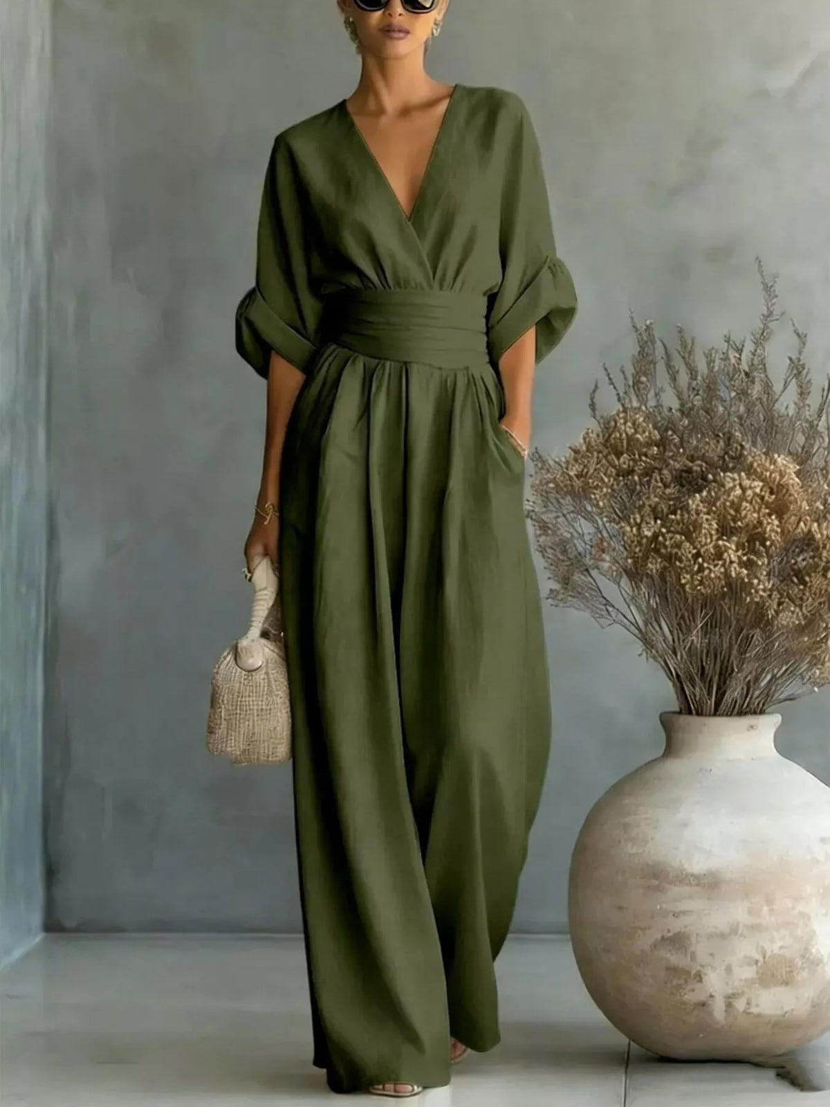 Dark green half-sleeve wide-leg jumpsuit with V-neck and cinched elastic waist