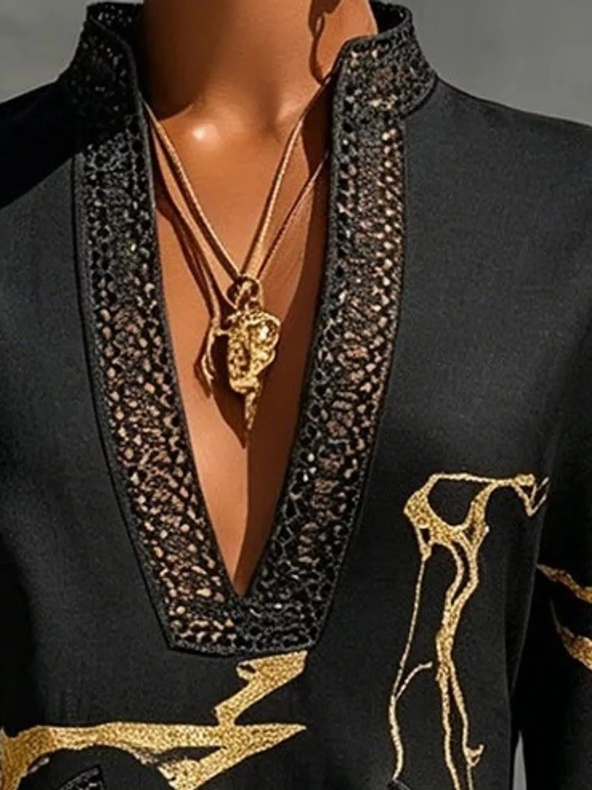 Black relaxed-fit mini dress with notched V neckline, lace trim, and gold embroidery accents