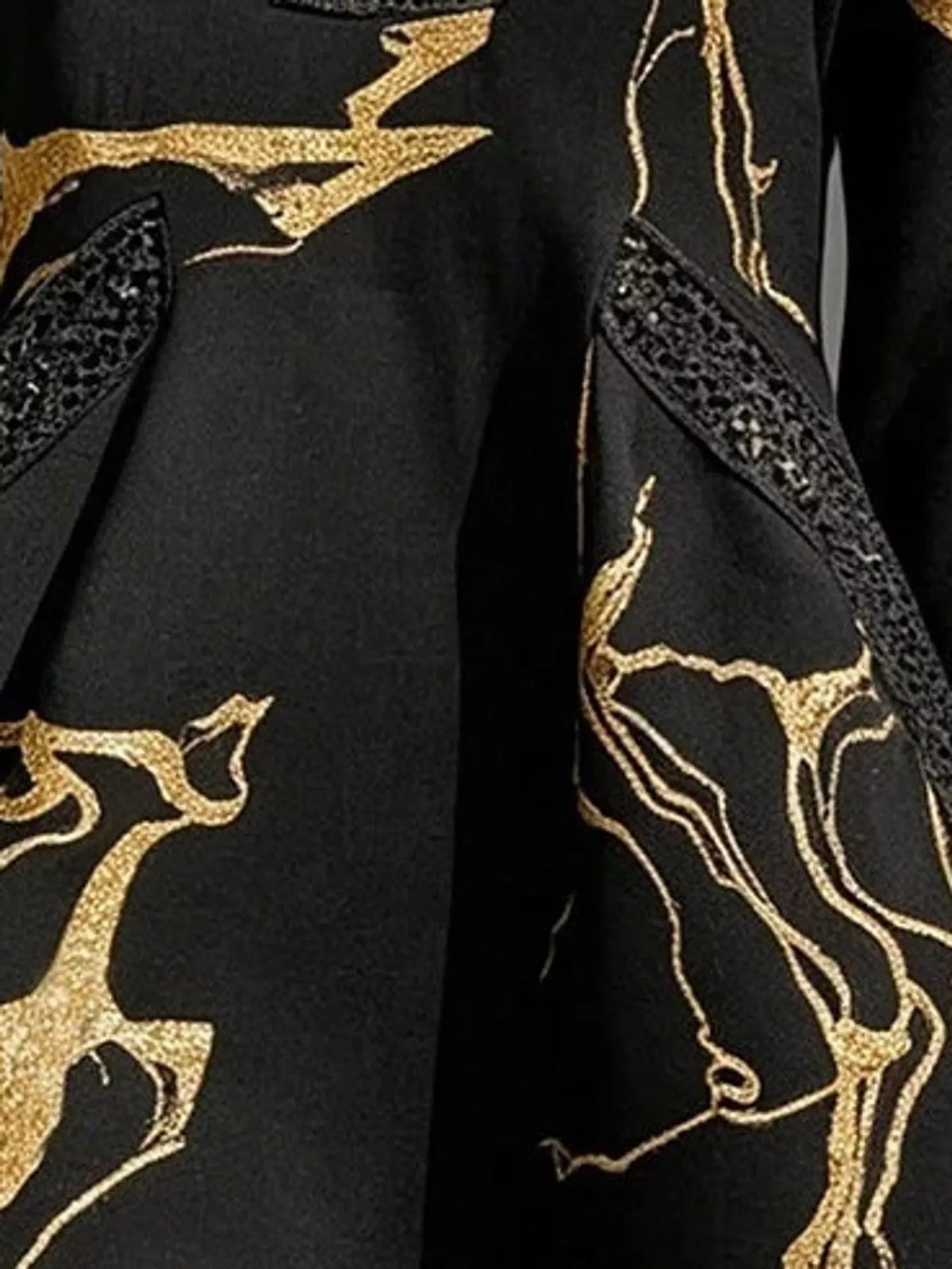 Black relaxed-fit mini dress detail with gold accents and lace-trimmed notched V neckline