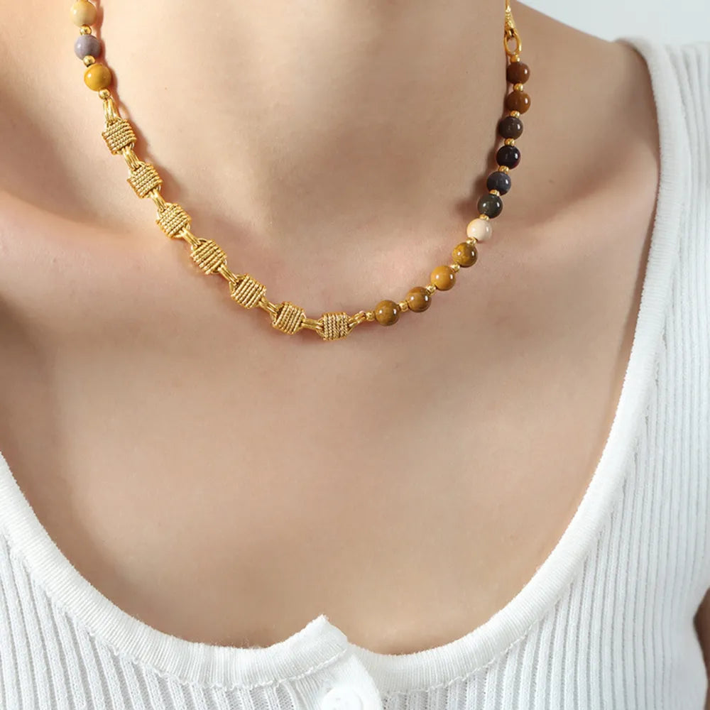 Gold beaded necklace with multicolor beads and braided texture spacer segments