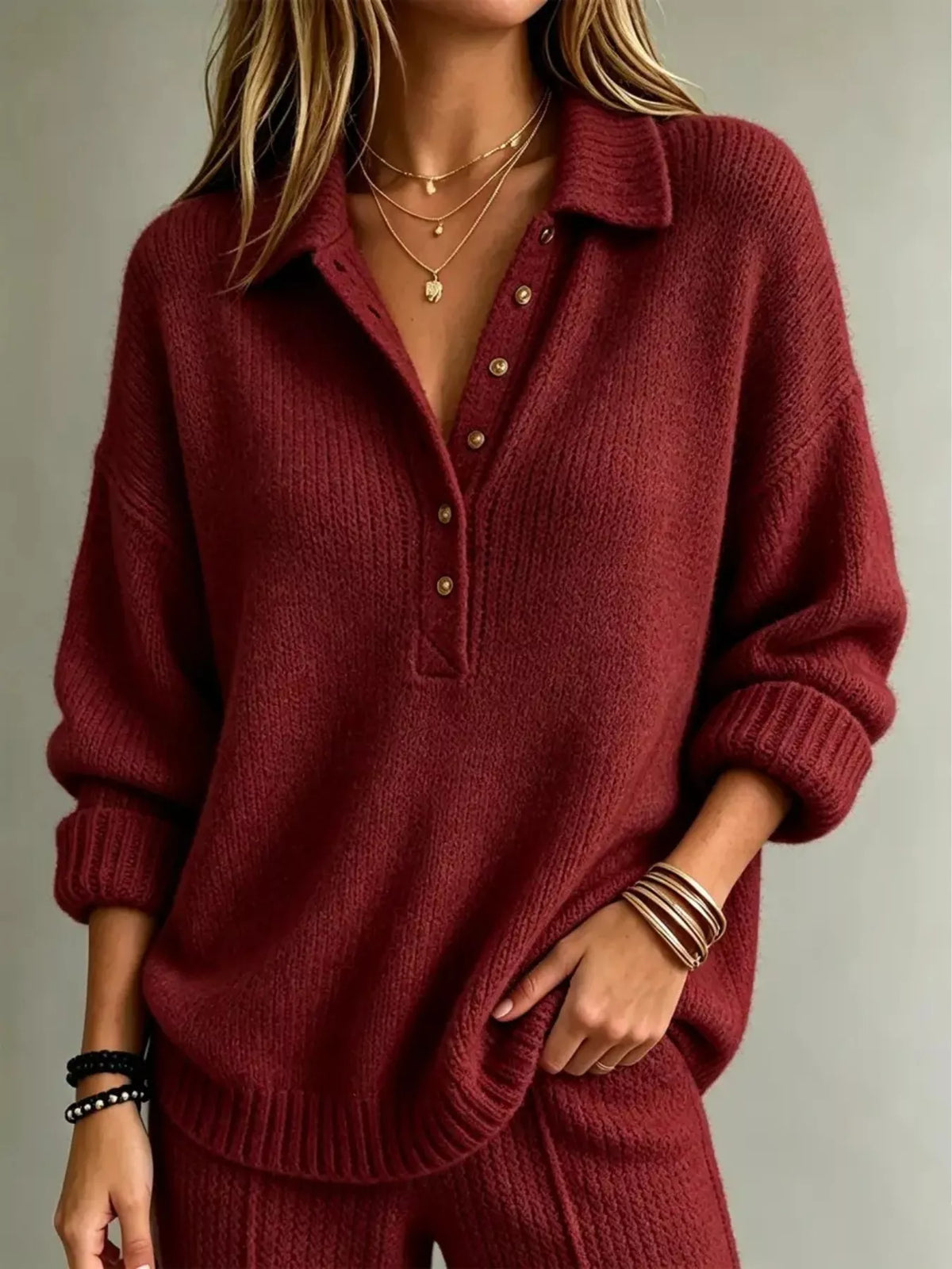 Burgundy red button-front dropped-shoulder sweater with henley placket and gold buttons.