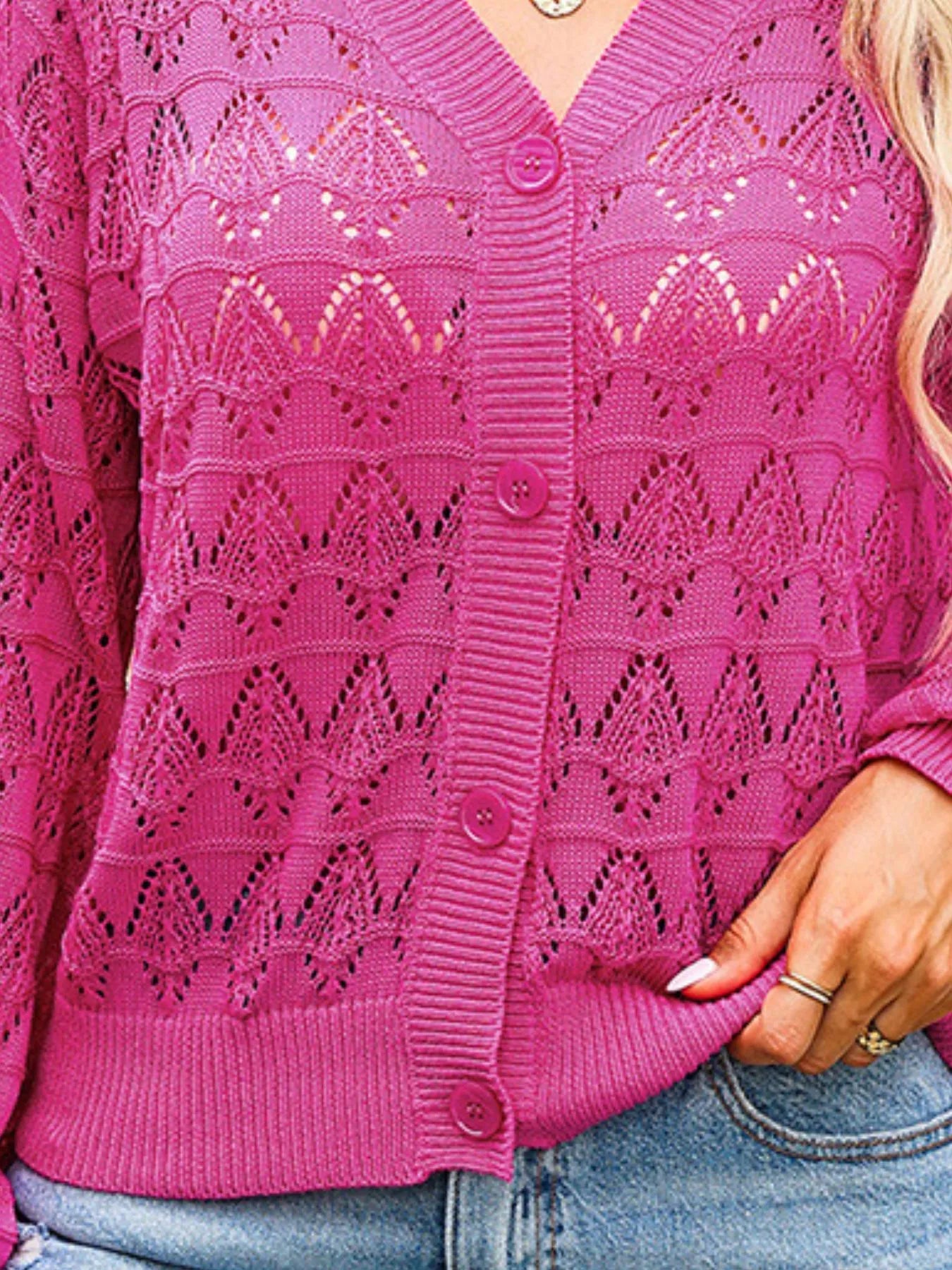 Rose pink openwork button-up cardigan close-up with button placket and eyelet knit pattern