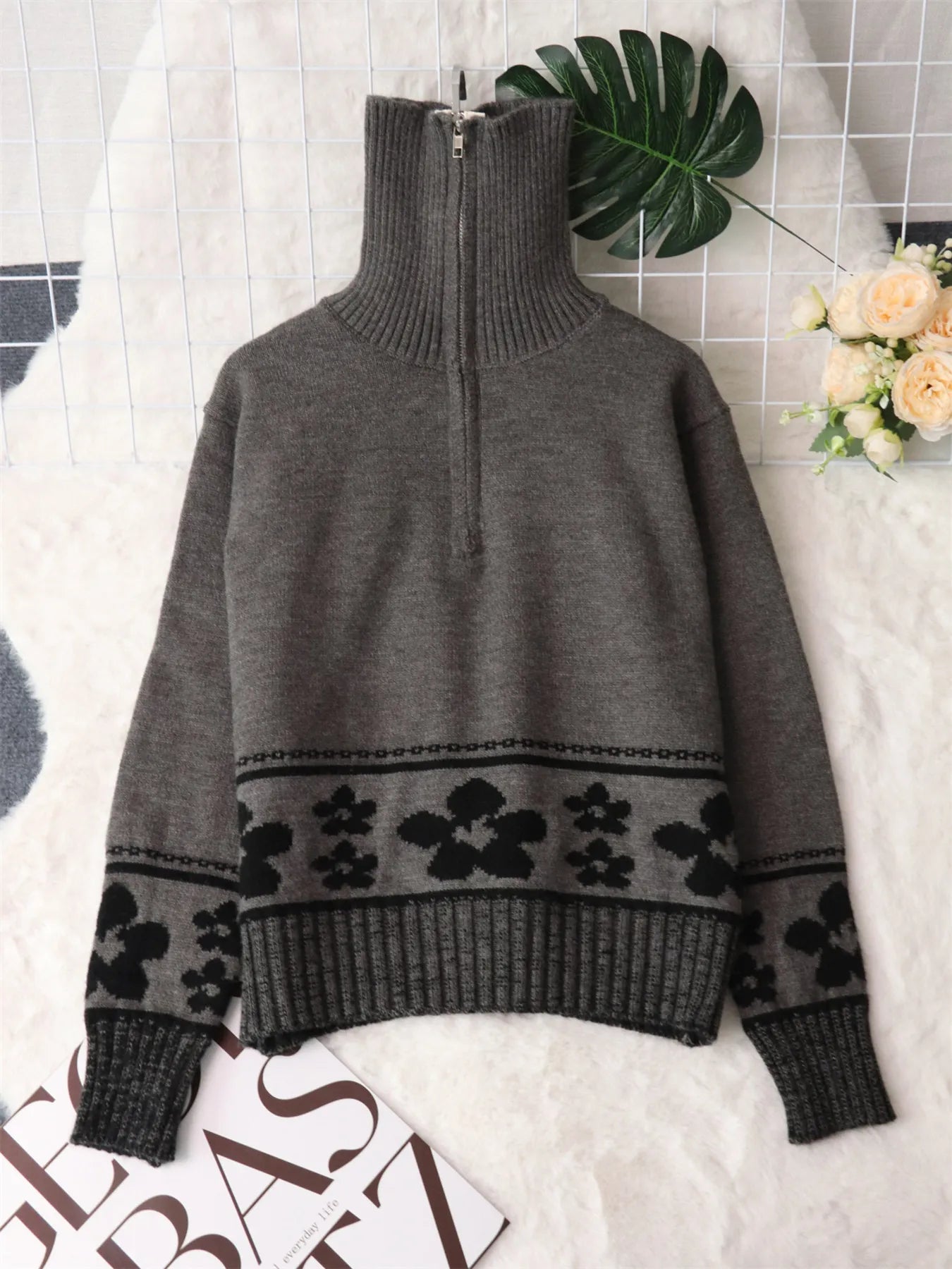 Gray ribbed turtleneck sweater with black floral stripe band across the midsection