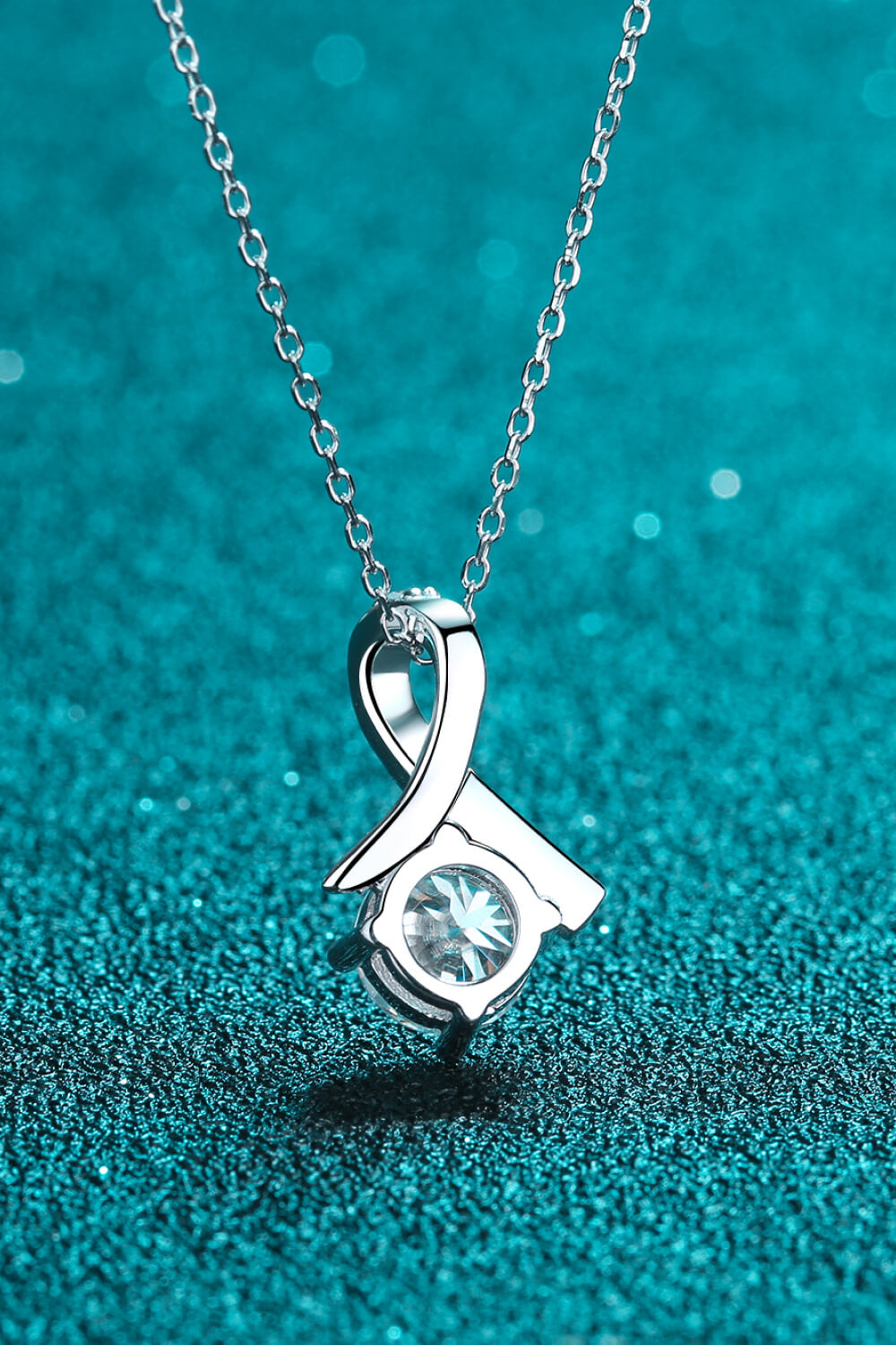 Silver moissanite pendant necklace with heart-shaped frame and round center stone
