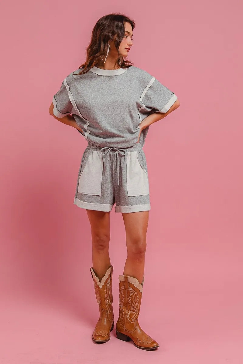 Heather grey terry knit shorts with elastic waistband, drawstring, and side pockets