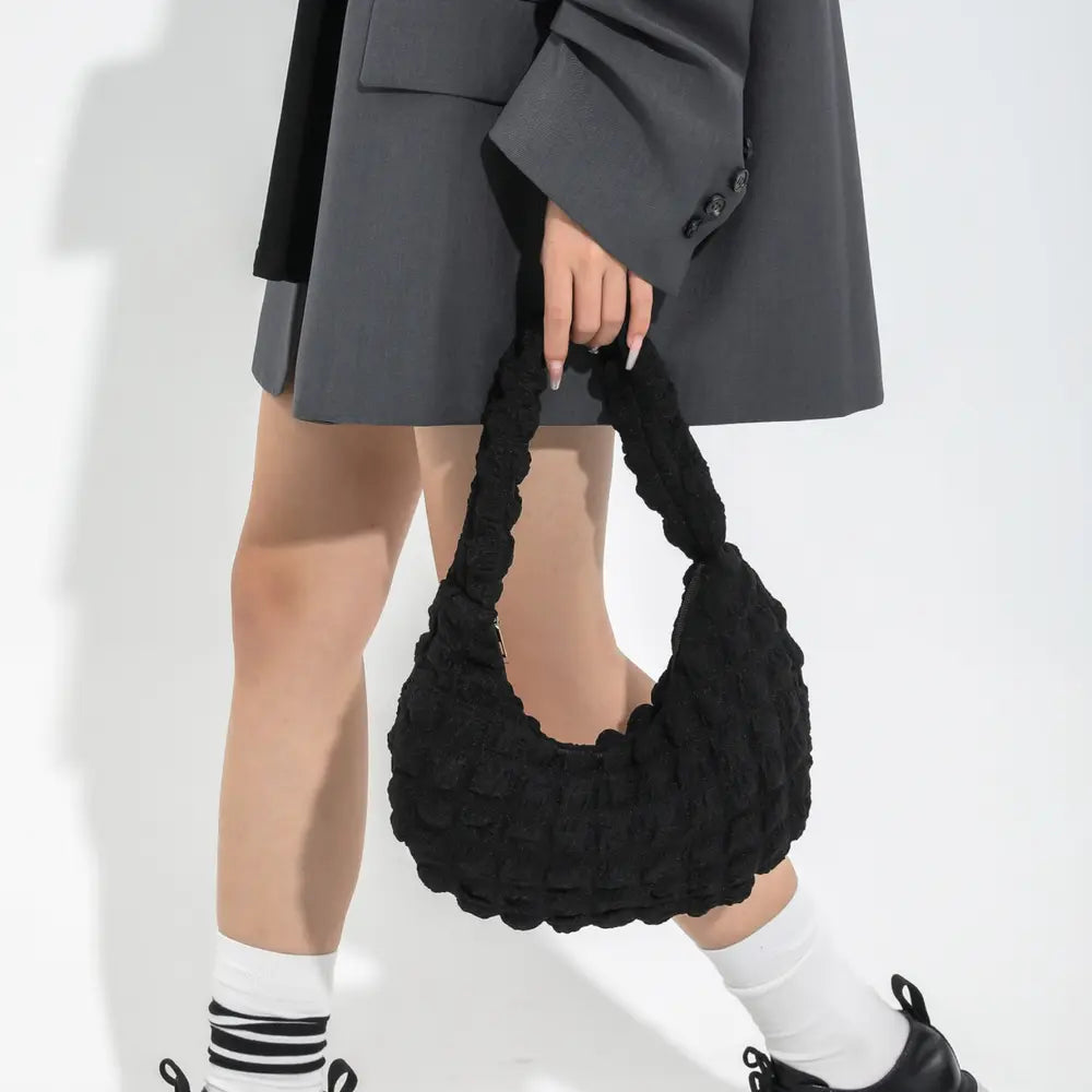 Black textured small hobo handbag carried over the shoulder