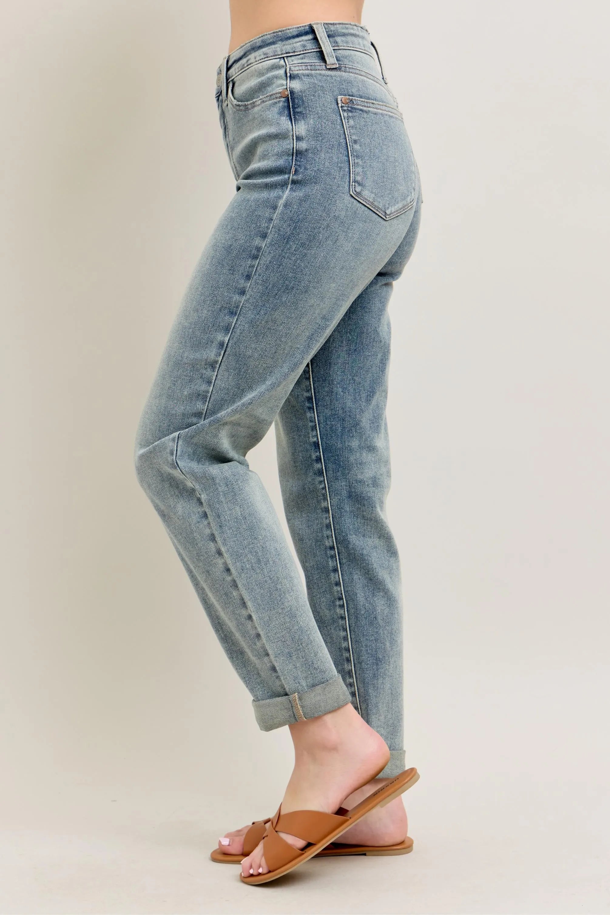 Light blue vintage-wash jeans angled side view with double roll cuff hem
