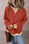 Rust red long-sleeve sweatshirt with light V-contrast yoke and ribbed hem