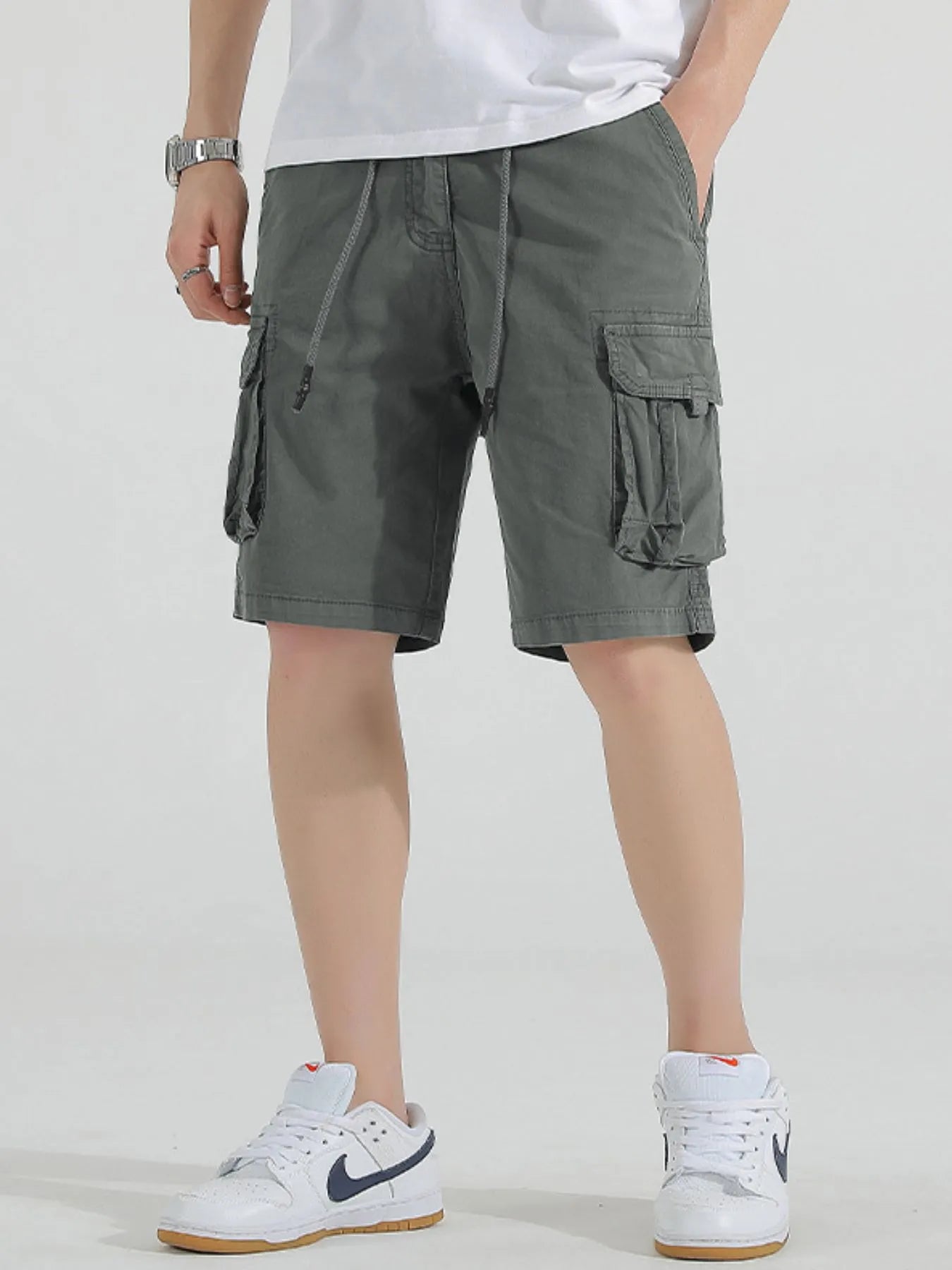Olive drawstring cargo shorts with flap cargo pockets and side drawstring waist