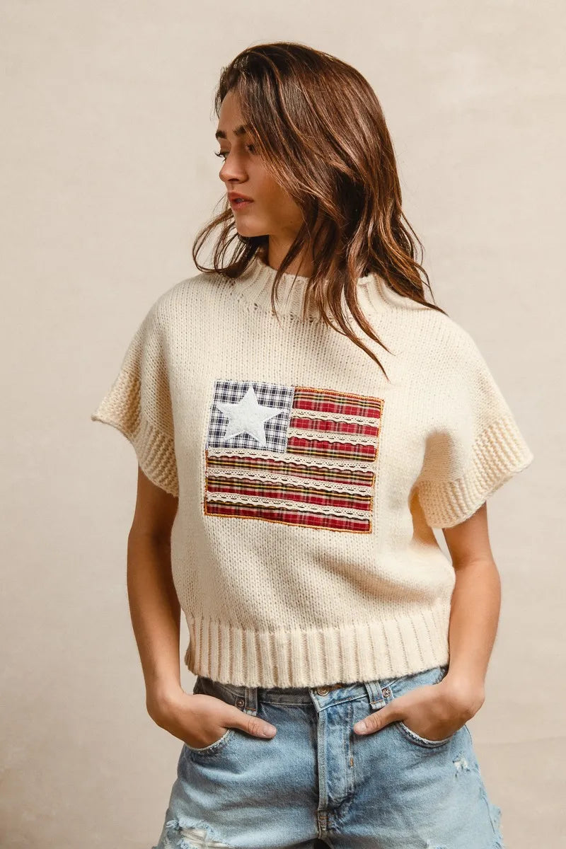 Oatmeal drop-shoulder knit sweater with short sleeves, crew neck, and flag patch