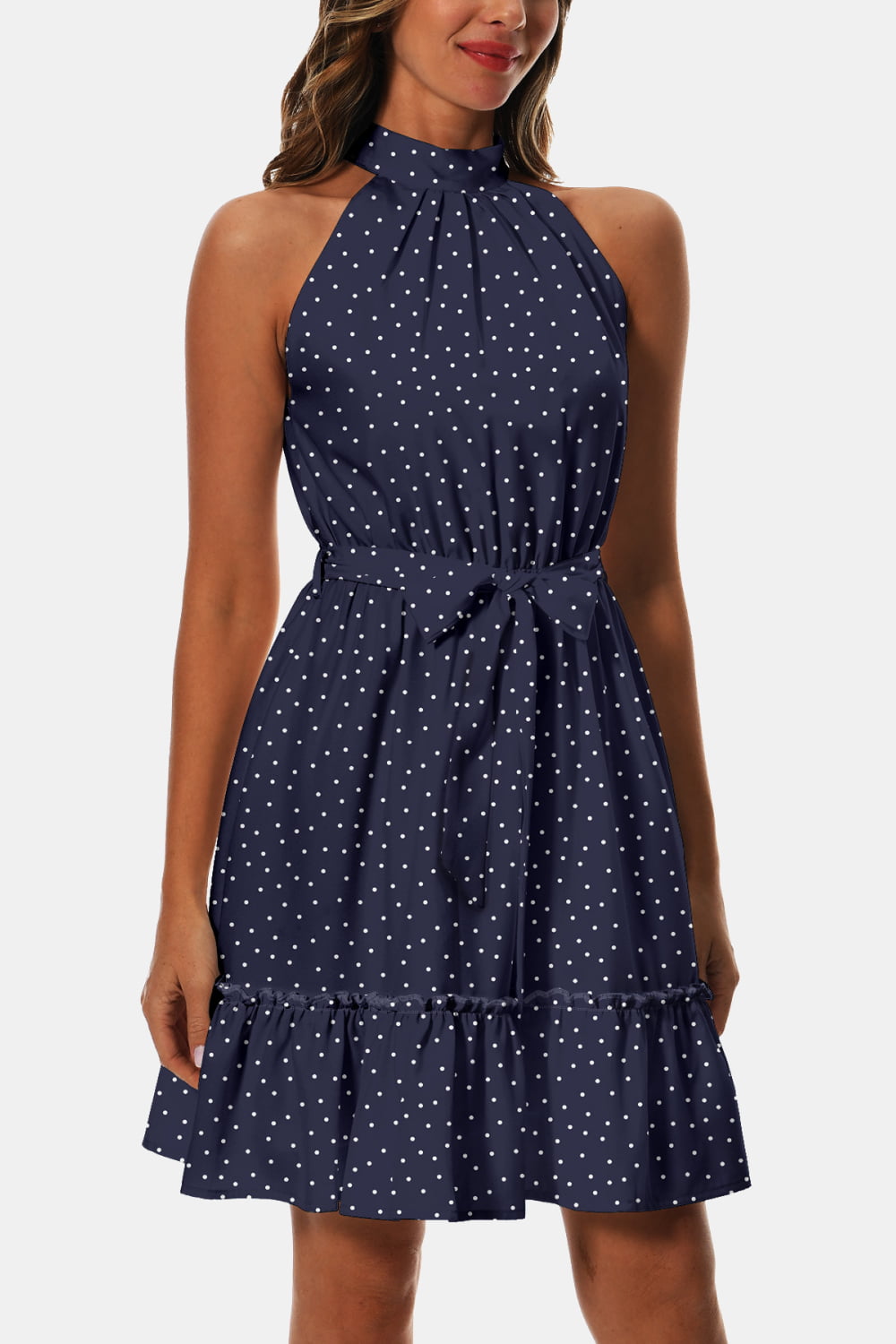 Navy printed halter dress with tie waist and ruffled hem, white dot scatter pattern