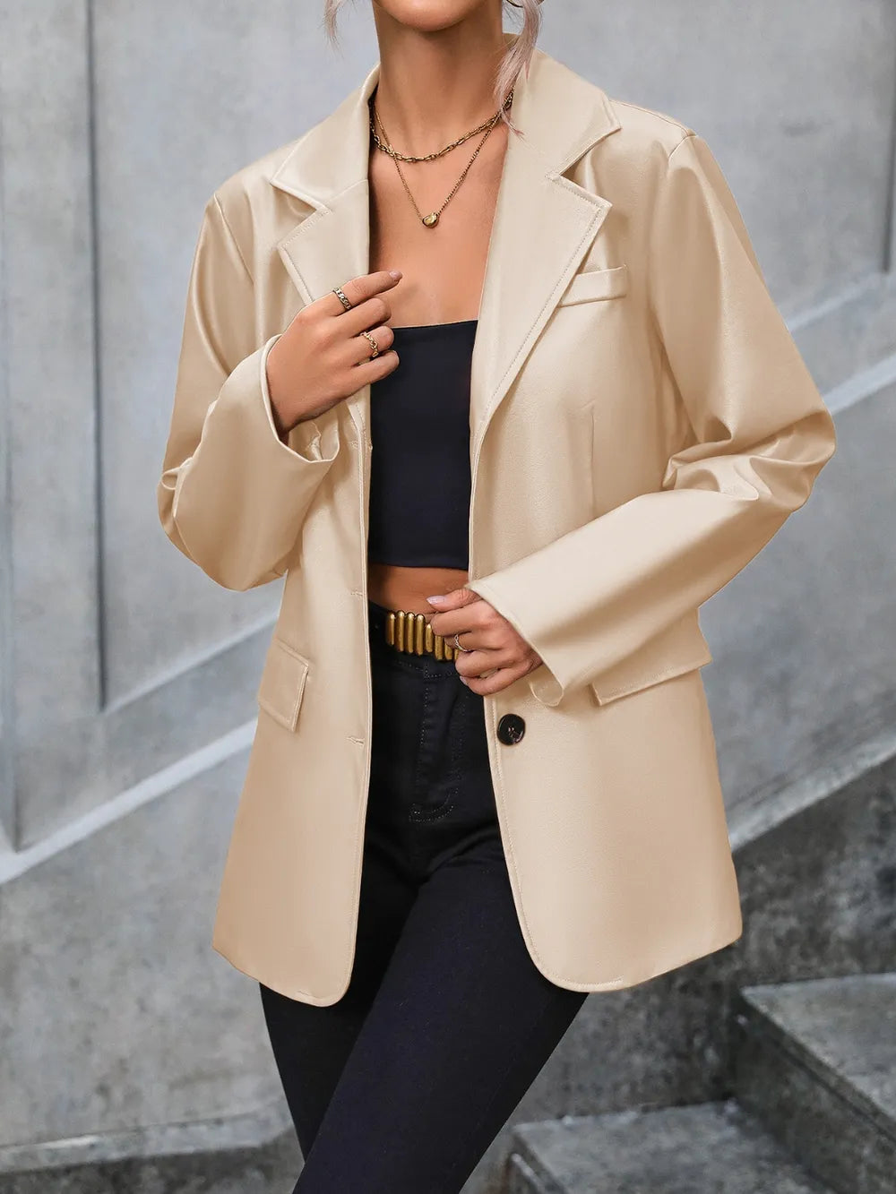 Tan button-up blazer with collared neckline, long sleeves, flap pockets, and button front