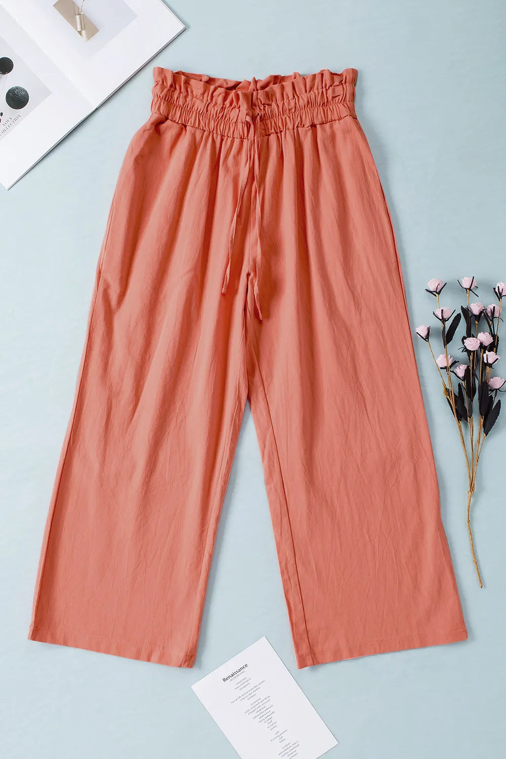 Coral drawstring paperbag waist wide-leg pants with gathered waist and wide cropped legs.