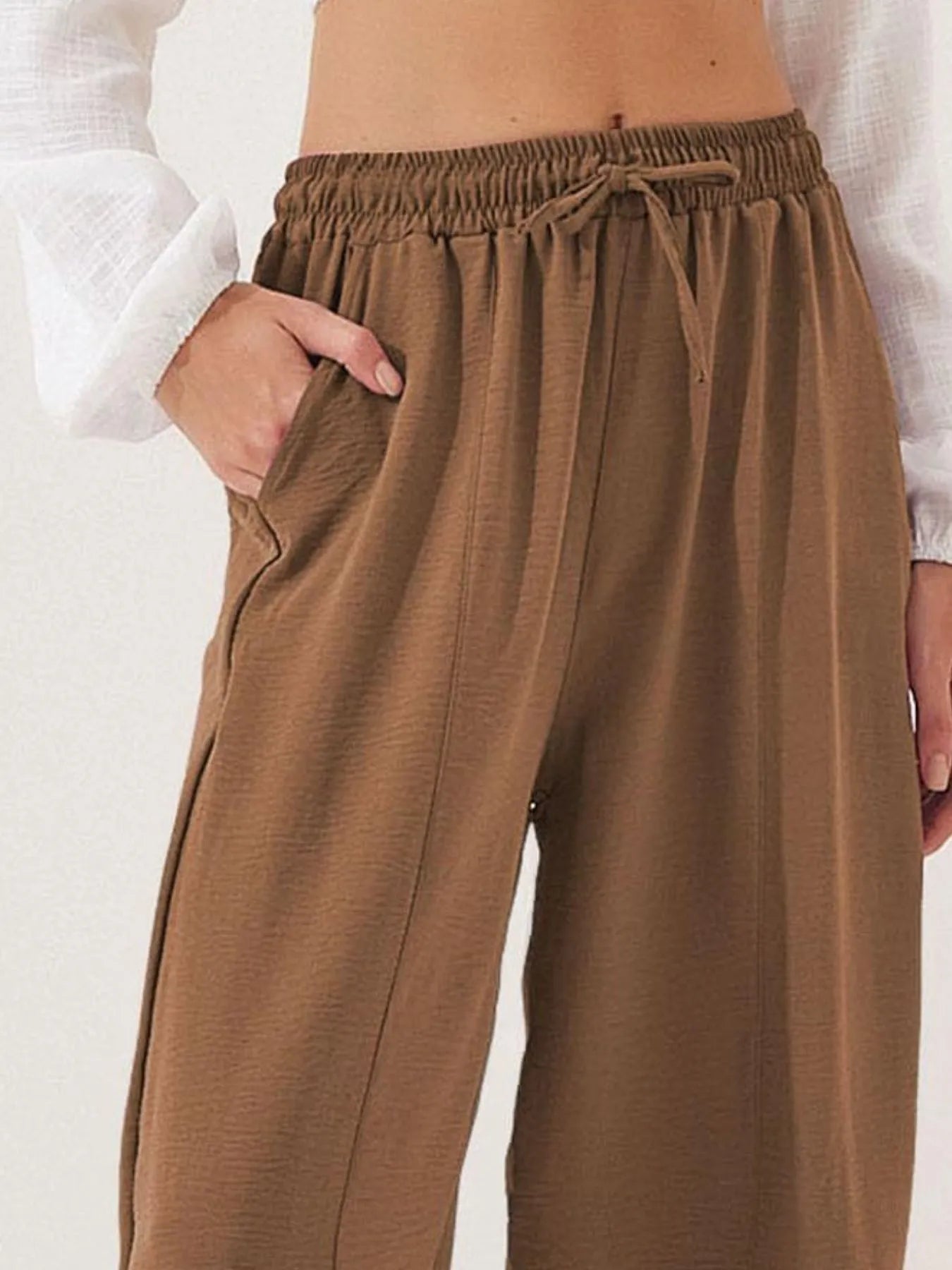 Cropped wide-leg pants in brown with elastic waist and tied drawstring