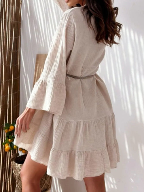 White striped long sleeve dress, V-neck button front, tiered ruffle skirt and tie waist