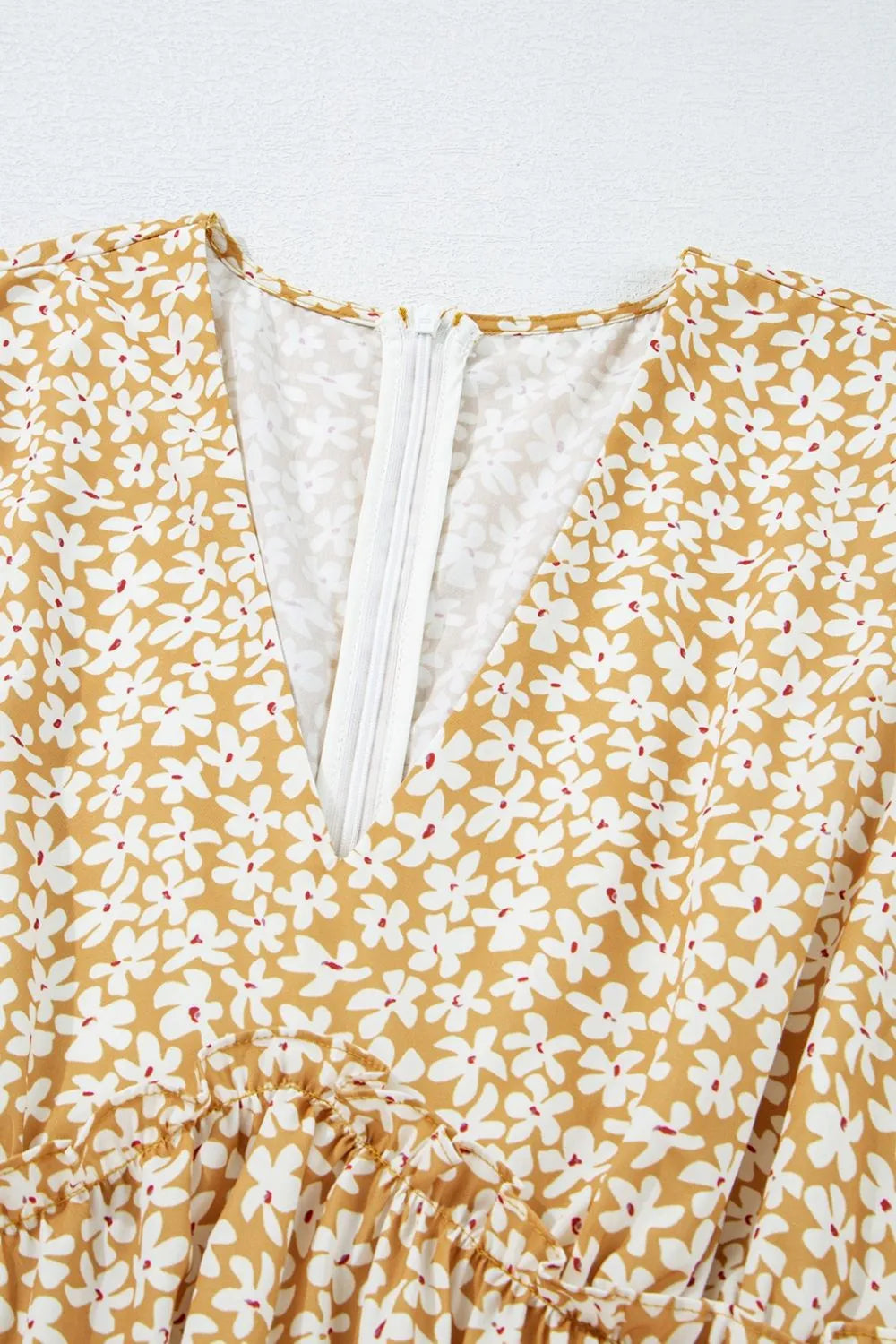 Floral short-sleeve surplice mini dress in mustard yellow with white flowers and back zipper