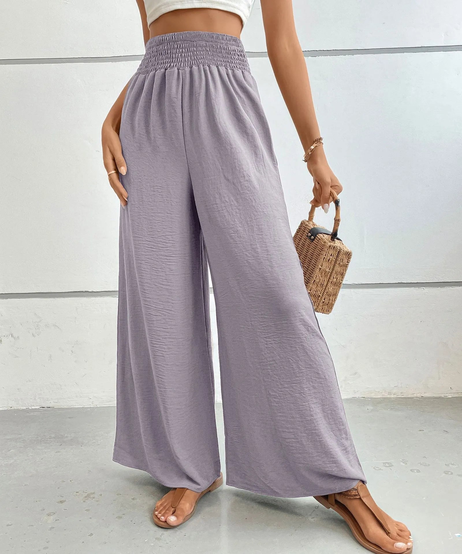High-waisted wide-leg pants in lilac with elastic waistband and loose wide-leg silhouette.