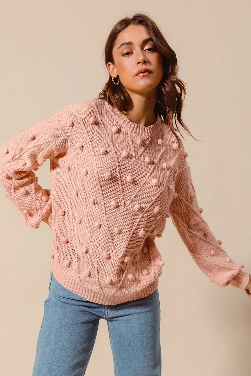 Blush pom-pom knit crewneck sweater with raised dot texture and long sleeves