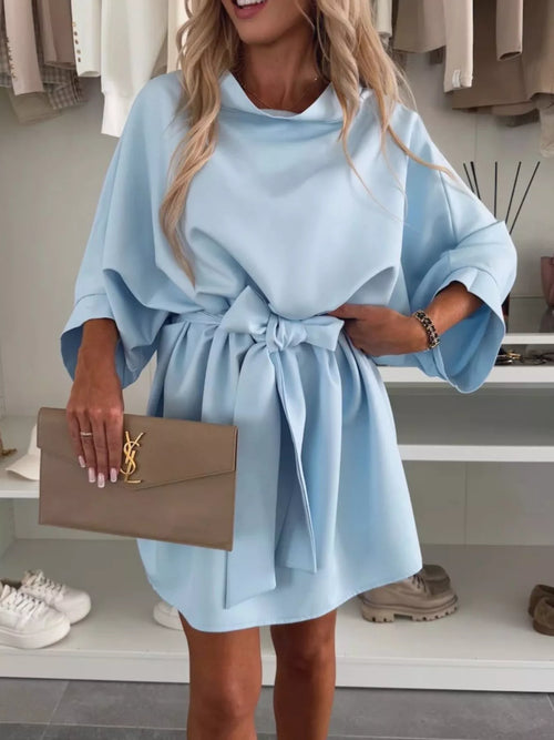 Light blue batwing sleeve mini dress with tie waist belt, flowing skirt