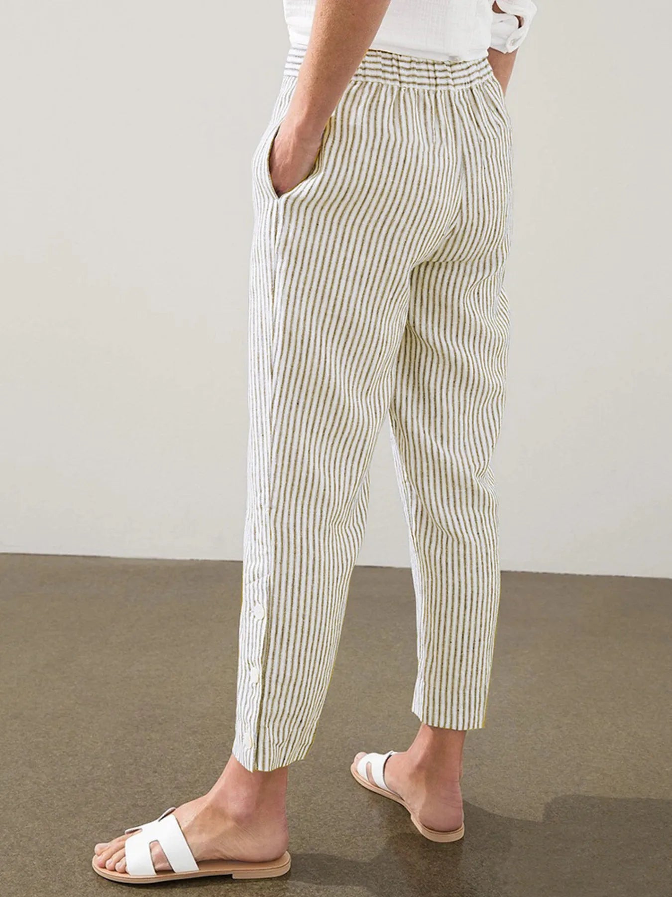 Plus size striped side-button detail pants in light yellow and white, relaxed leg
