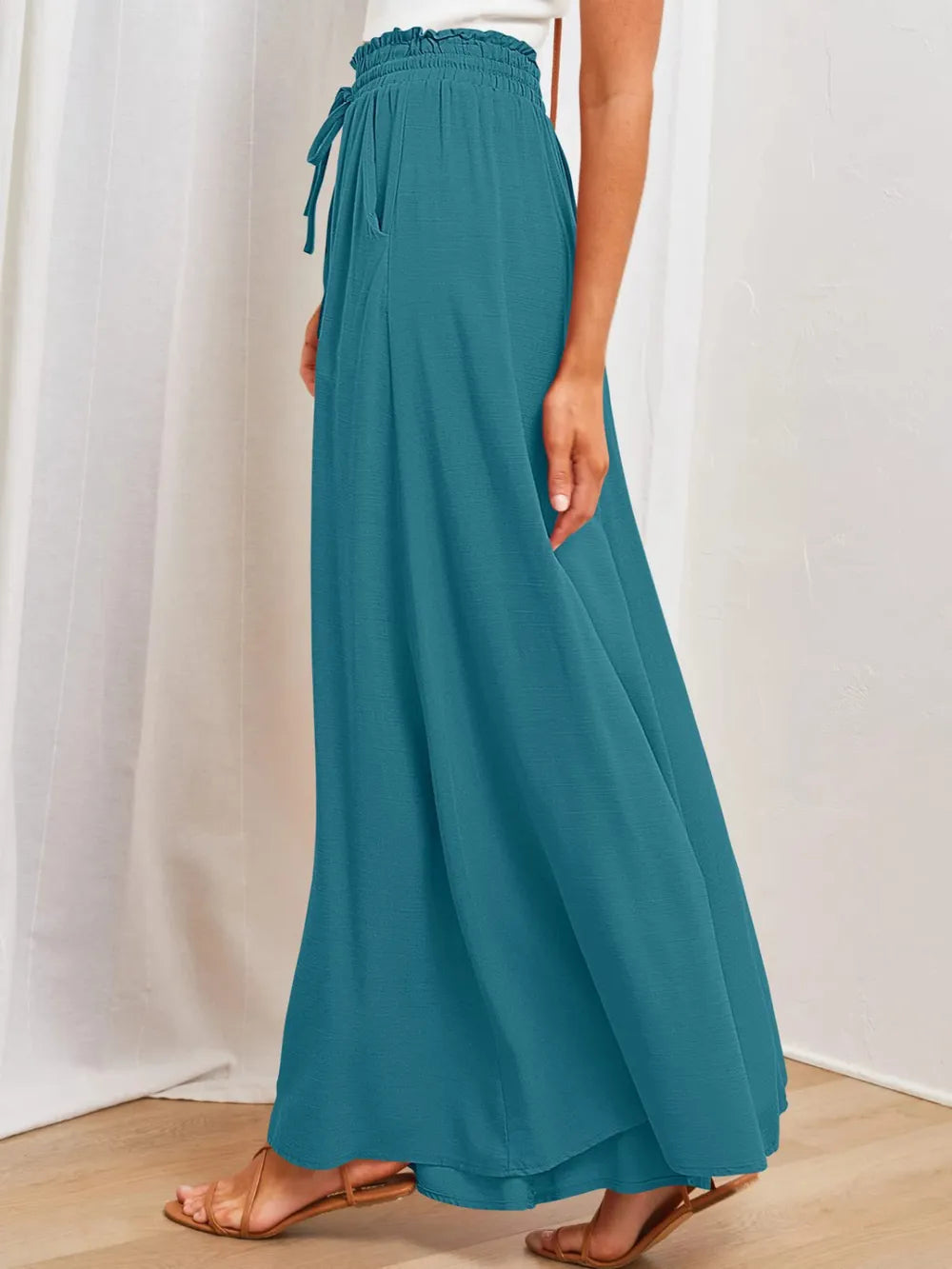 Teal wide-leg pants with elastic drawstring waist and side pockets