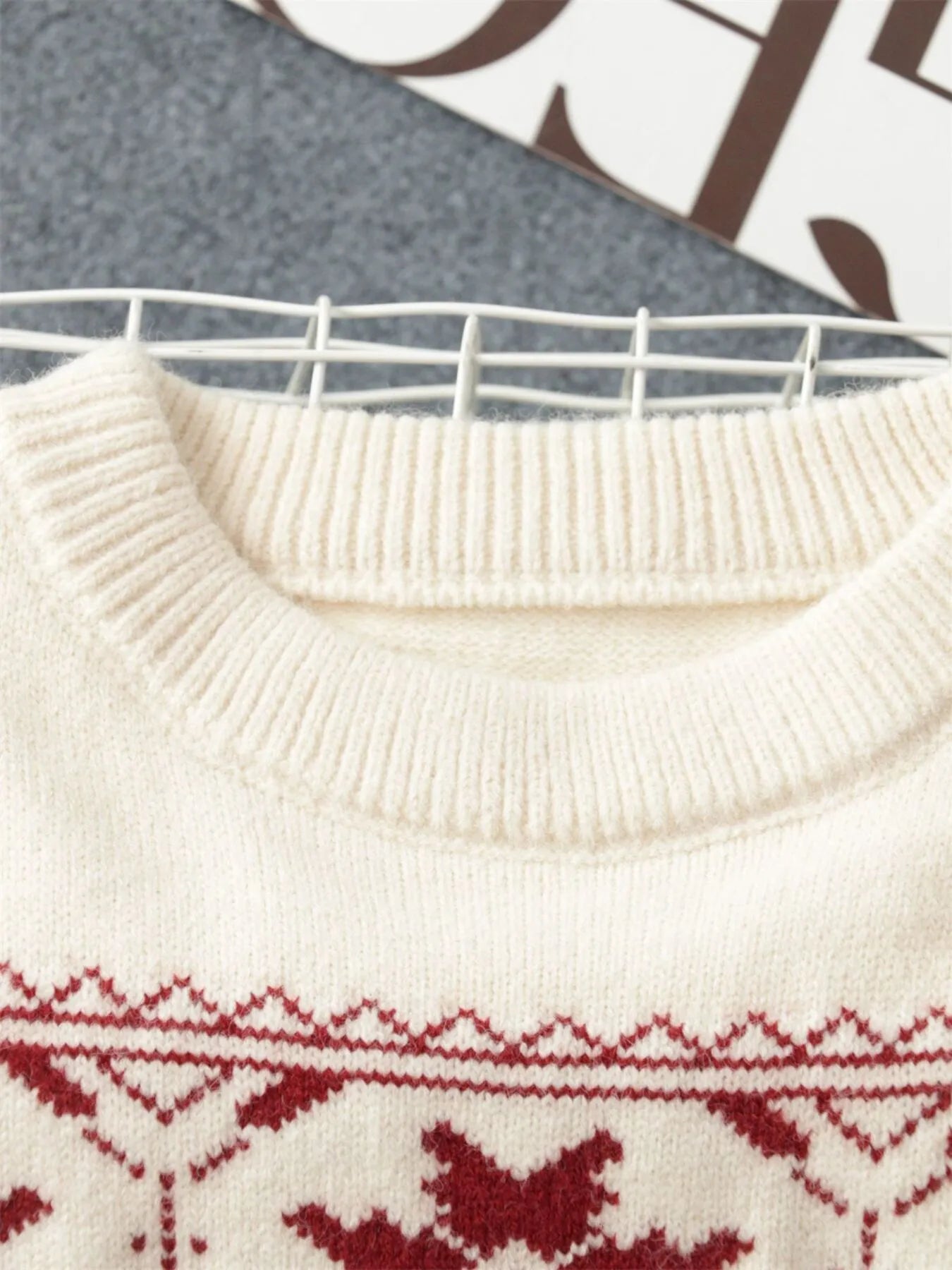 White ribbed crew neck knit with red snowflake Fair Isle pattern detail below collar