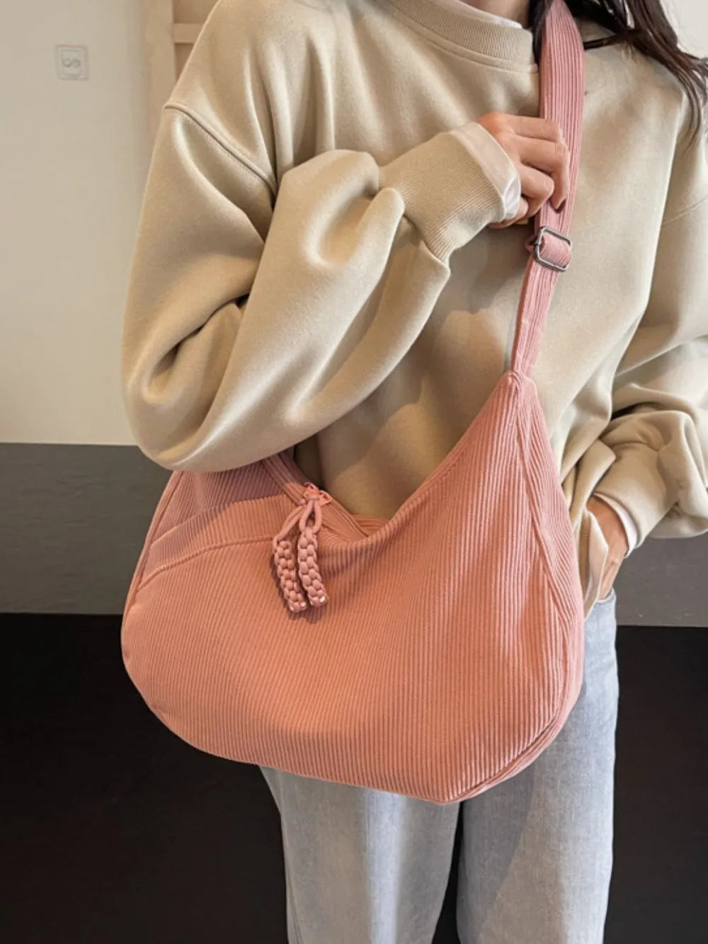 Ribbed pink shoulder bag with braided drawstring and adjustable strap