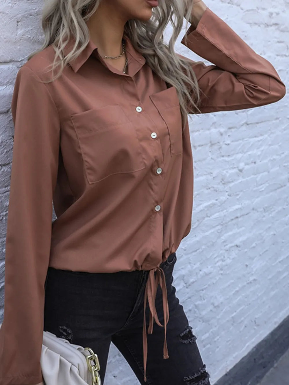 Caramel long-sleeve button down shirt with tied hem, chest pocket, visible buttons