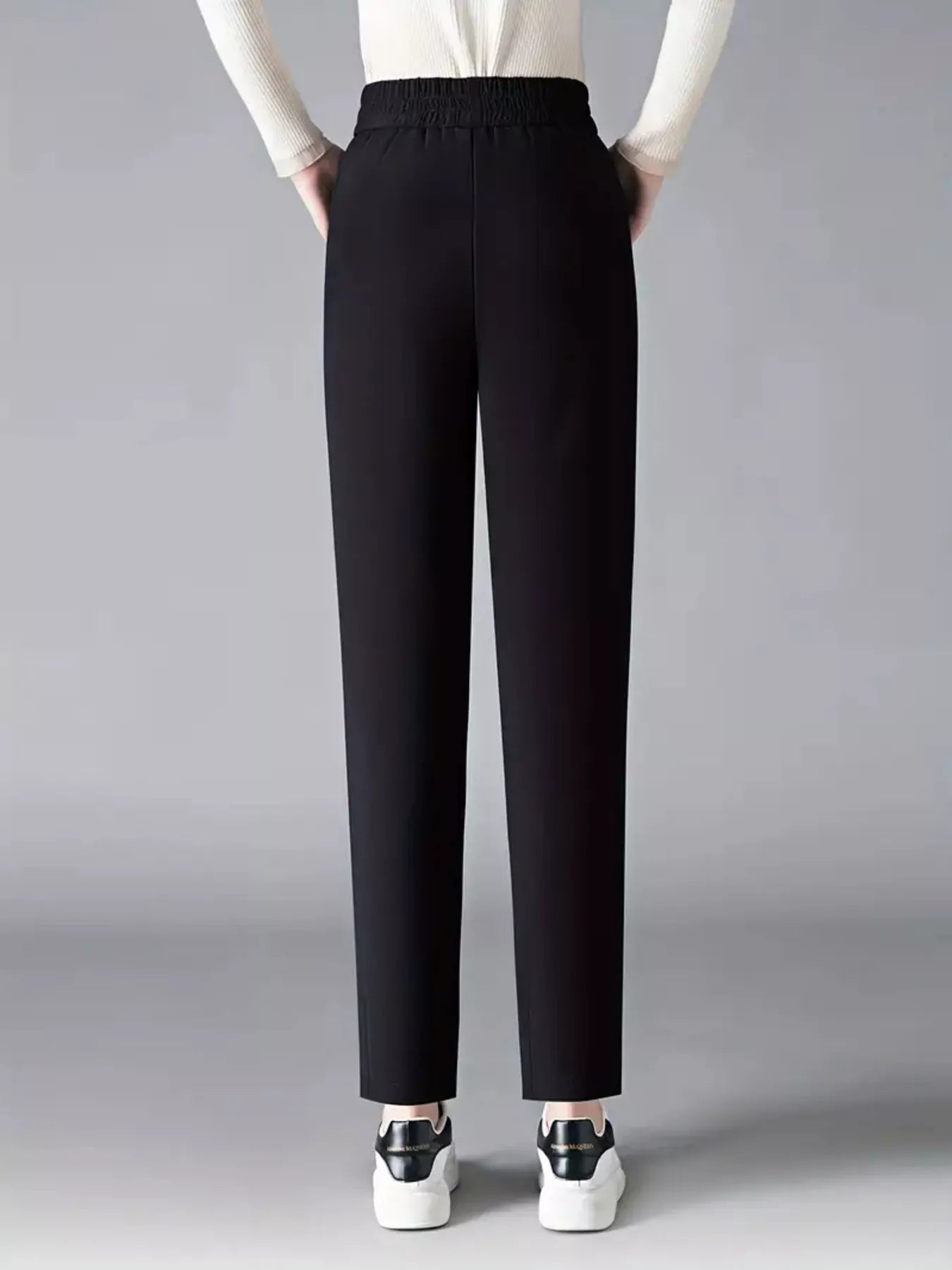 Elastic waist loose fit pants in black with straight, tapered-to-ankle legs