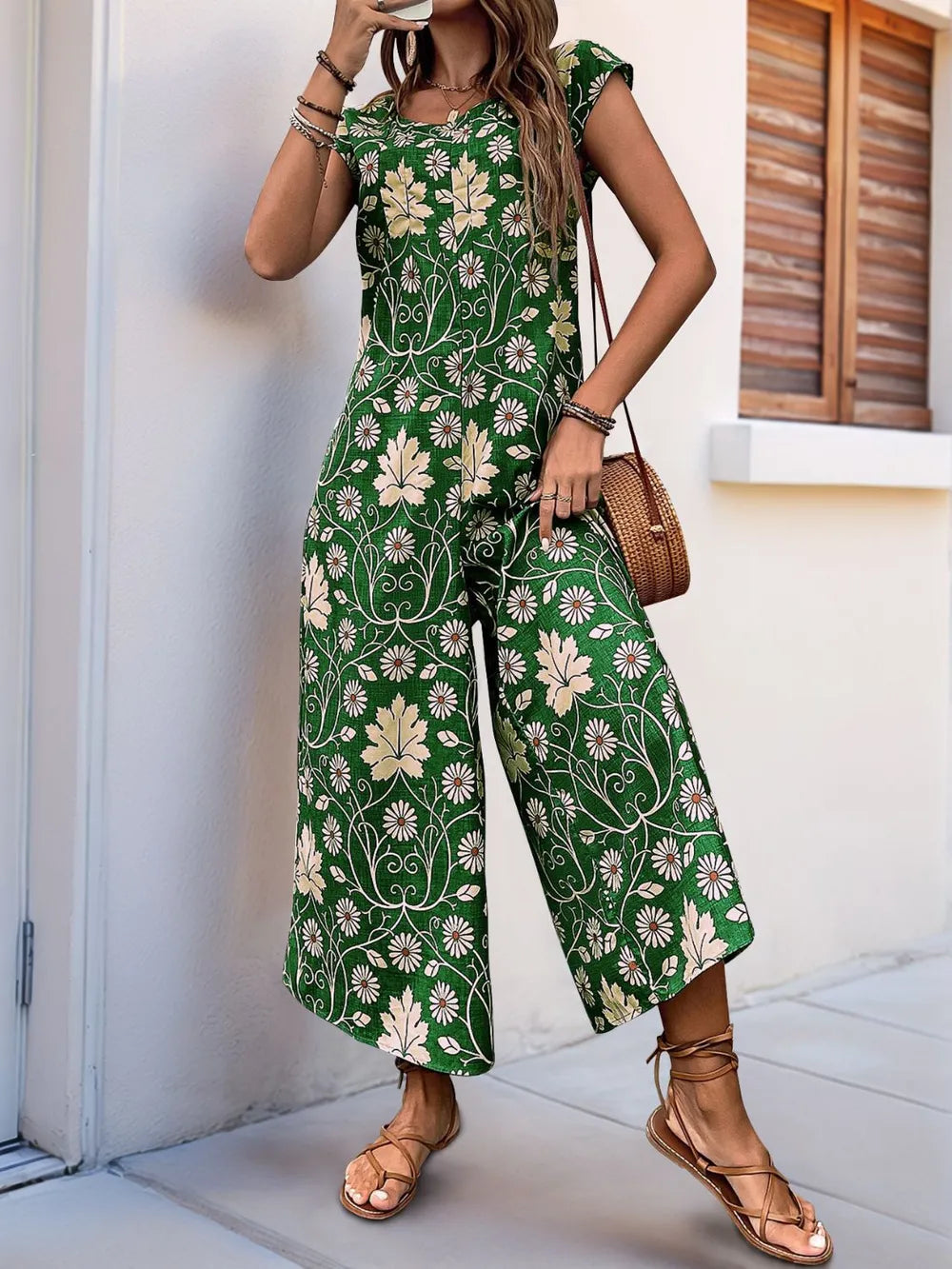 Green printed wide-leg jumpsuit with round neckline and flowy wide legs