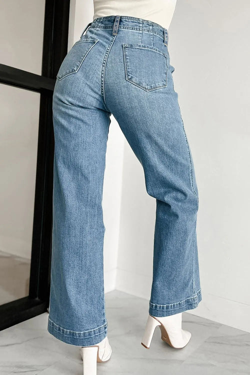 High-waist medium-blue button-fly jeans with back patch pockets and wide leg