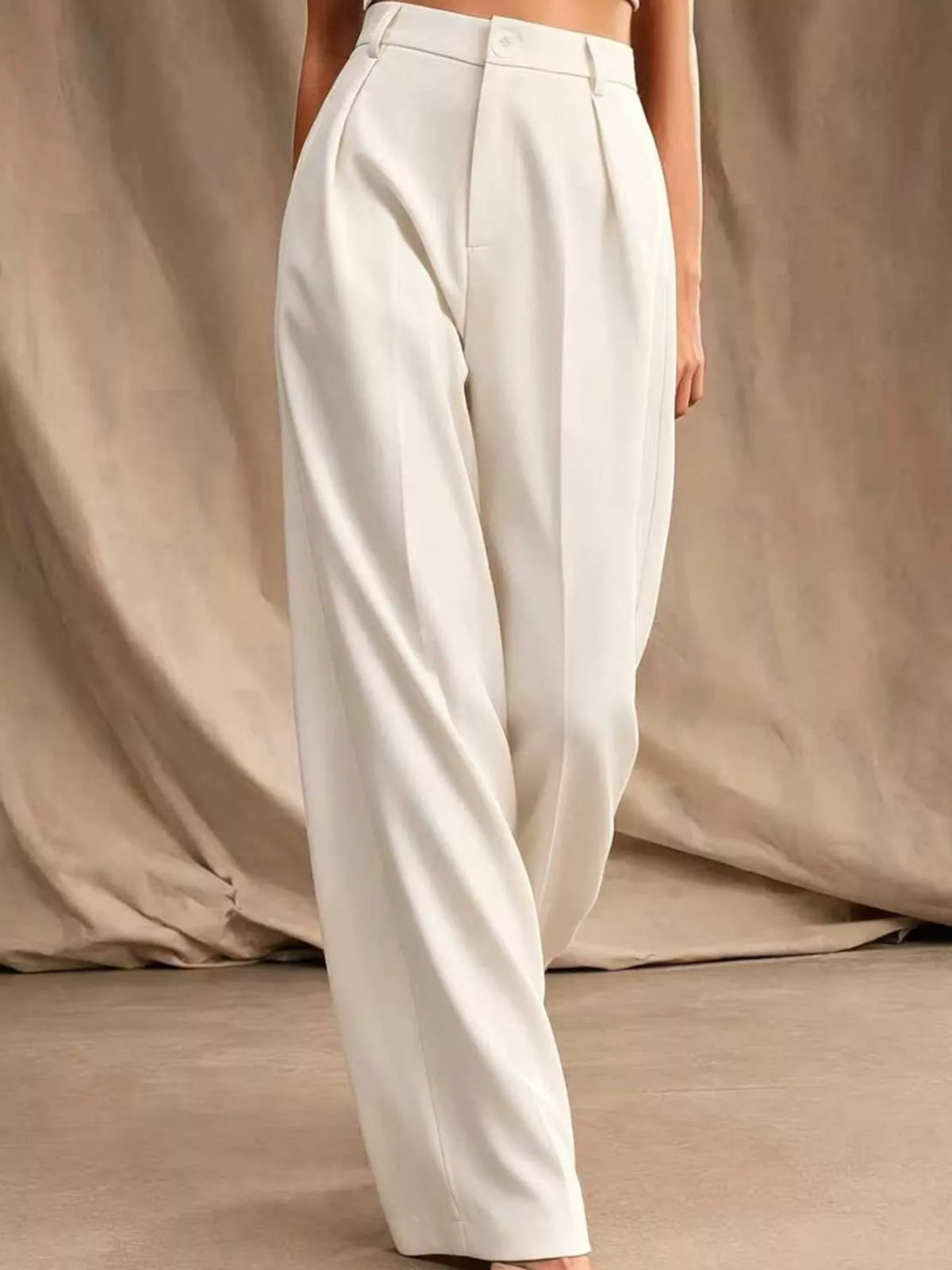 Off-white high-waisted pleated wide-leg pants with front pleats and button closure