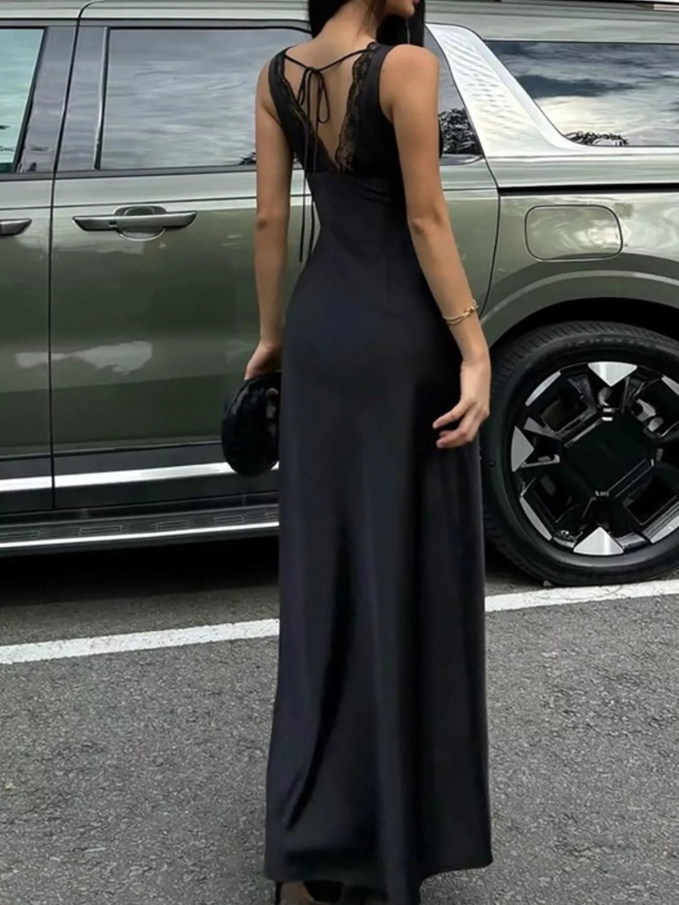 Black sleeveless maxi dress with open back and lace panel at the back neckline.