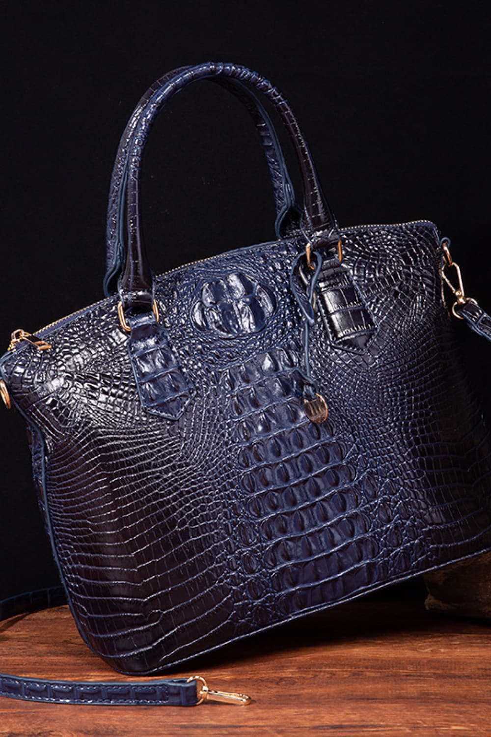 Vegan leather handbag in dark blue with side strap, embossed crocodile texture, and top handles
